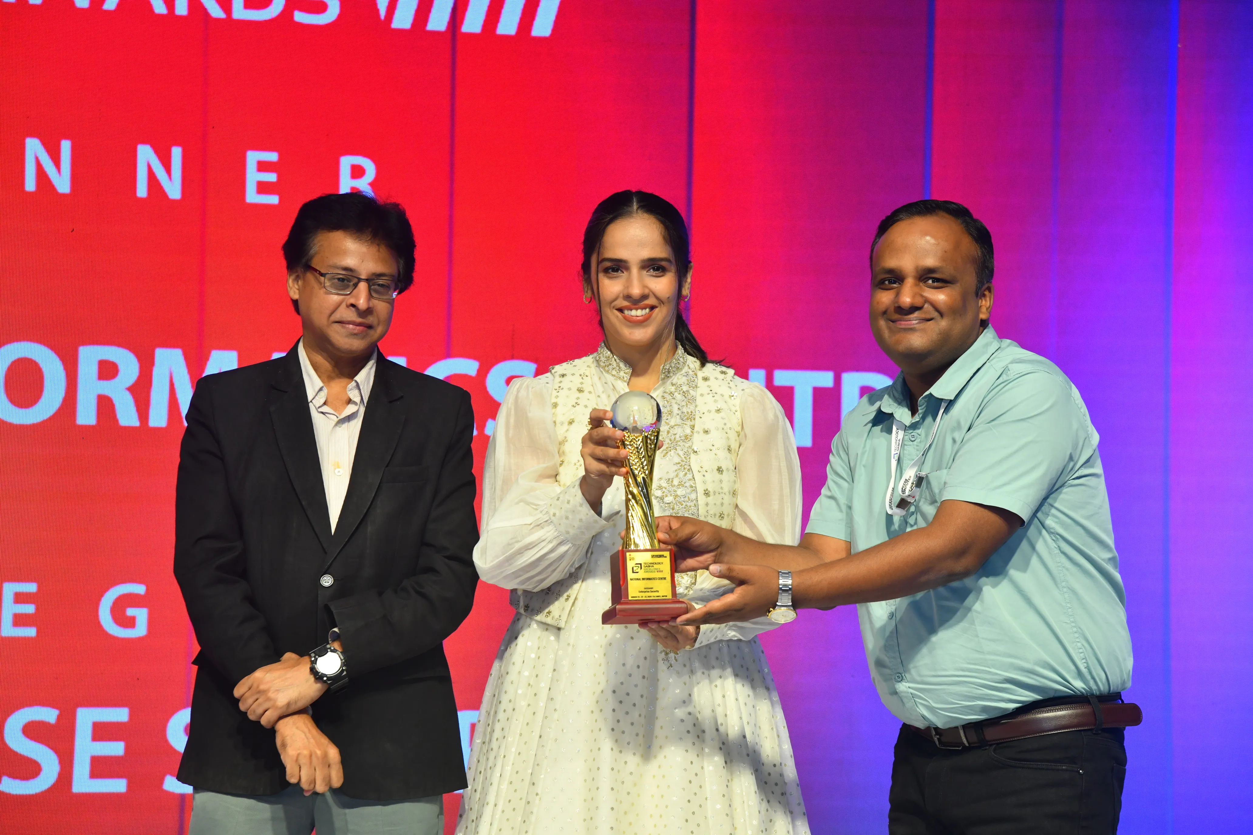 Close-up: trophy handover moment with Saina Nehwal at Technology Sabha Excellence Awards 2026
